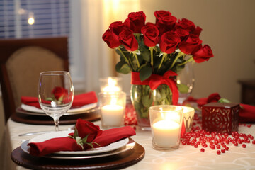 Romantic valentine's dinner table with red roses and candles