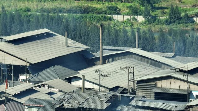 Aerial view drone footage reveals industrial estates releasing smoke into the sky, highlighting the urgent need for cleaner technologies. Greenhouse gases and Carbon monoxide concept.  