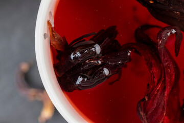 delicious red tea from rose buds on the table
