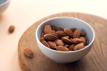Almonds in a bowl on a wooden board