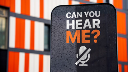 Can you hear me? on a sign in a city business district