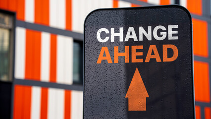 Change Ahead on a sign in a city business district - obrazy, fototapety, plakaty