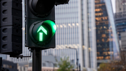 Traffic light with a green arrow in the city of London