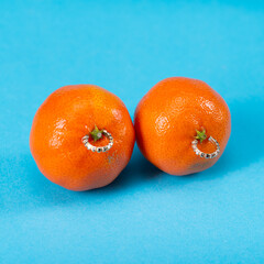 Intimate piercing. Minimal piercing concept. Tangerines with piercings