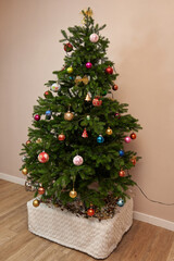 Christmas tree with beautiful toys on a stand