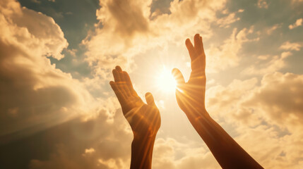 Two hands reaching upwards towards the sunlight