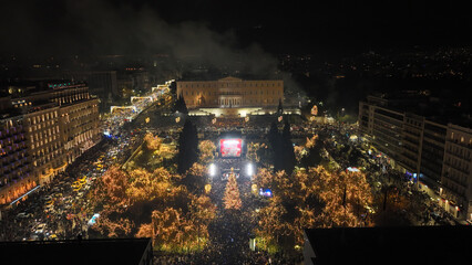 Fototapeta premium Aerial drone night shot of illuminated iconic Syntagma square at new year's eve celebration with fireworks welcoming 2024, Athens, Attica, Greece