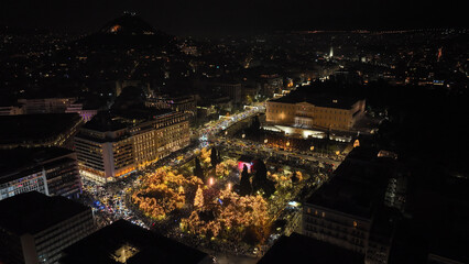 Aerial drone night shot of illuminated iconic Syntagma square at new year's eve celebration with fireworks welcoming 2024, Athens, Attica, Greece