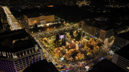 Obraz premium Aerial drone night shot of illuminated iconic Syntagma square at new year's eve celebration with fireworks welcoming 2024, Athens, Attica, Greece