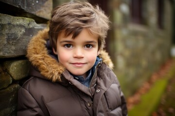 Outdoor portrait of a cute little boy, wearing a warm coat