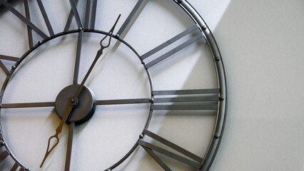 Close-up of an iron frame clock hanging on the wall