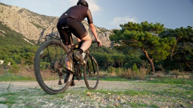 Male cyclist riding a gravel bike at sunset at the mediterranean sea in Kara&ouml;z, Turkey