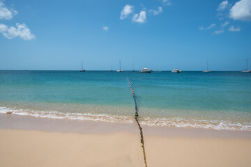 Fishing nets stretch put into the Caribbean sea from Reduit beach - 701417266