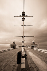 A sepia toned image of the view along Blackpool North pier towards the Irish Sea - 701418425
