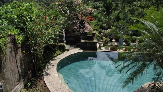 Hd slow motion footage of swimming pool at balinese hotel in the middle of the jungle, Ubud, Bali, Indonesia.
Low angle, tilt movement.