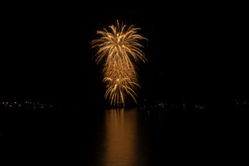 New Year's Eve fireworks over the channel in Marina del Rey, CA celebrate east coast midnight.