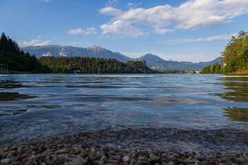 Beautiful alpine lake Bled - in Slovenia, amazing landscape. View of the lake, island with church, Bled Castle, mountains and blue sky with clouds.