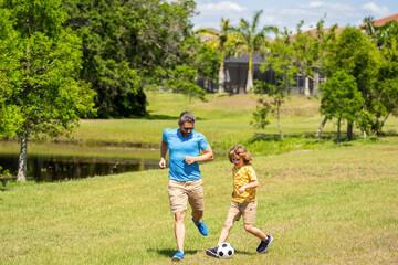 adventures between father and son. Active father son playing football in summer. Father and child son teaming up outdoor. Father dad and son enjoying outdoor activities together. summer park together