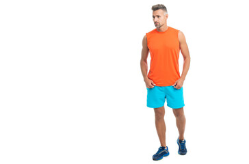 Fototapeta premium athletic man during a yoga class, advertisement. athletic man posed before sporty fitness competition. sporty athletic man in tshirt isolated on white. A standing athletic man at the gym studio