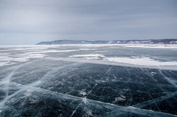 Crystallized lake Baikal with transparent ice, sky in the background
