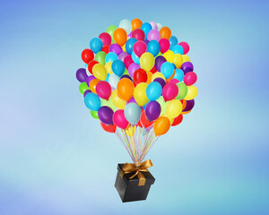 Naklejka premium Many balloons tied to gift box on bright background