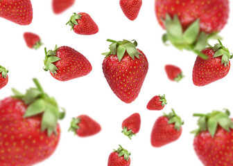 Fresh ripe strawberries falling on white background