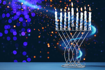 Hanukkah celebration. Menorah with burning candles on blue table against dark background with blurred lights, space for text