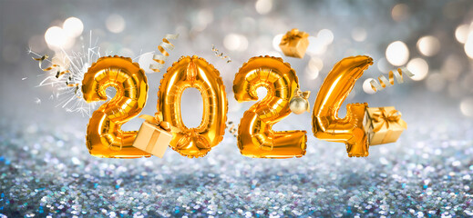 Happy New 2024 Year. Bright number shaped balloons, gift boxes and festive decor on blurred background. Banner design