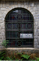 Vintage arch glass window in a stoned built building
