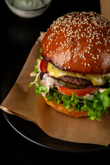Close up of junk food american burger black surface - 701455406