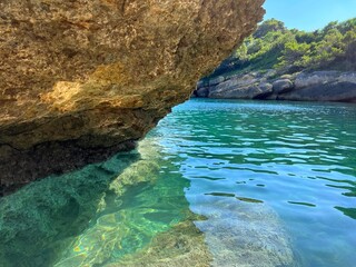 Rocky coast of beautiful Adriatic sea with clear turquoise blue water. 