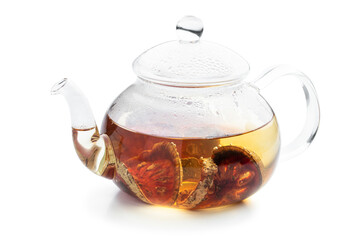 Bael fruit tea in glass teapot isolated on white