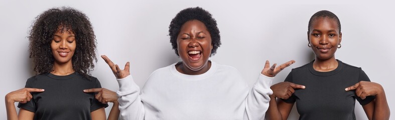 Horizontal shot of emotional chubby African woman exclaims loudly keeps hands raised up reacts to...