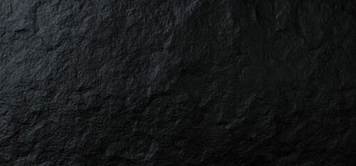 Photograph of a black slate surface with a wavy pattern. Reflects light and looks dimensional.