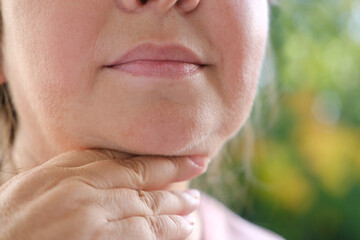 Double chin face mature woman 50 years old, human fat neck, sagging cheeks, wrinkles on skin,...