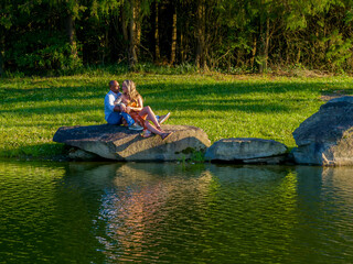 A Beautiful Young Interracial Couple Pose For Their Engagement Photographs Outdoors