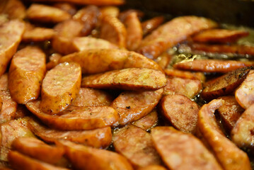 Fried baked sausage top view. Delicious European street food.