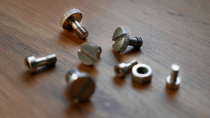 Bolts and nuts on a wooden table
