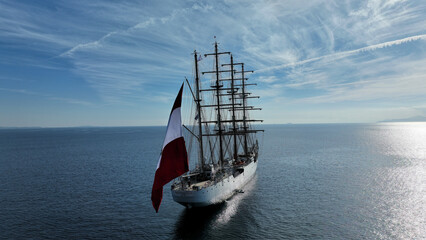 Aerial drone photo of beautiful 3 mast barque or barc type classic sailing wooden boat anchored in...
