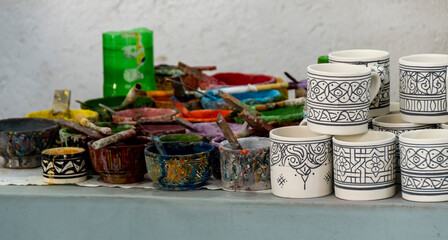 Workstation, with paints and brushes, in an artisan ceramics factory in Fes in Morocco