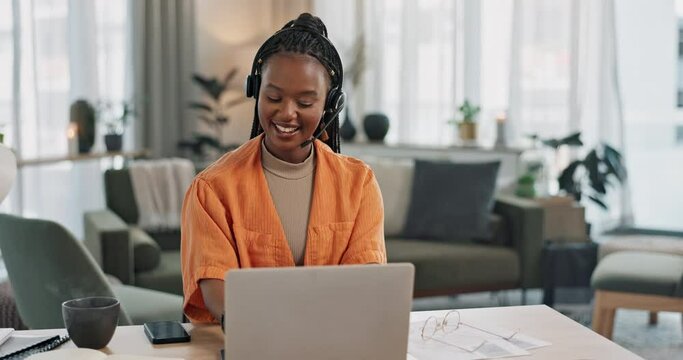 Black woman, headset in home office with laptop and phone call, remote work and crm in apartment. Virtual assistant at desk with computer, typing and conversation for advice, online chat and support