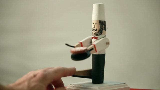 virtuoso chef tosses and turns pancakes in a frying pan, comic wooden push toy