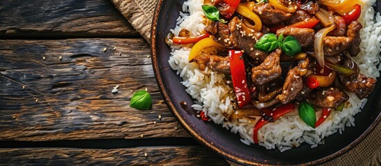 Stir fry Chinese pepper beef steak with onion red and green bell pepper rice in bowl. Creative Banner. Copyspace image - obrazy, fototapety, plakaty