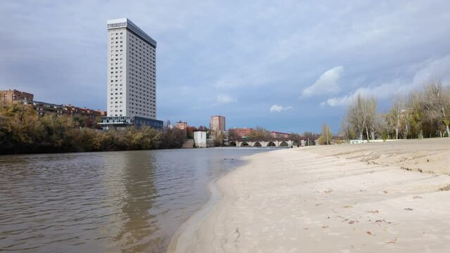 Sandy beach on the banks of the Pisuerga River as it passes through the city of Valladolid, Spain.