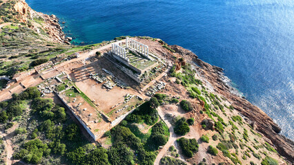 Aerial drone photo of iconic archaeological site of Cape Sounio and famous Temple of Poseidon built...