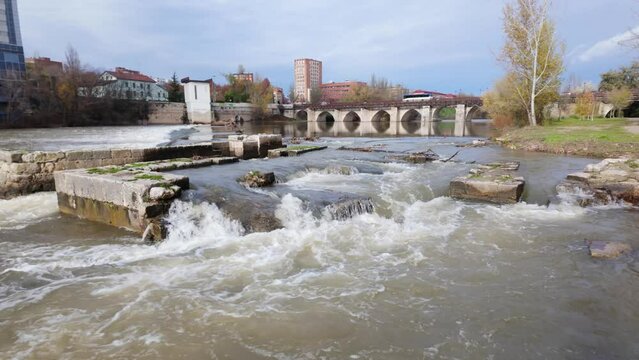 Roman bridge crossing the Pisuerga River in the monumental city of Valladolid, Spain.
