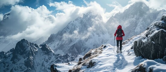 Woman trail runner cross country running up to winter snow mountain top. Creative Banner. Copyspace image