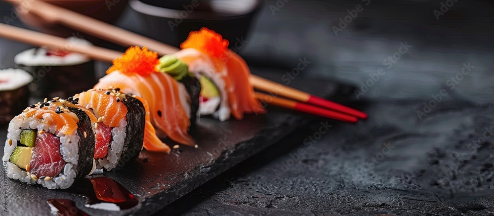 Poster sushi roll row of salmon tuna sushi rolls with chopsticks. creative banner. copyspace image