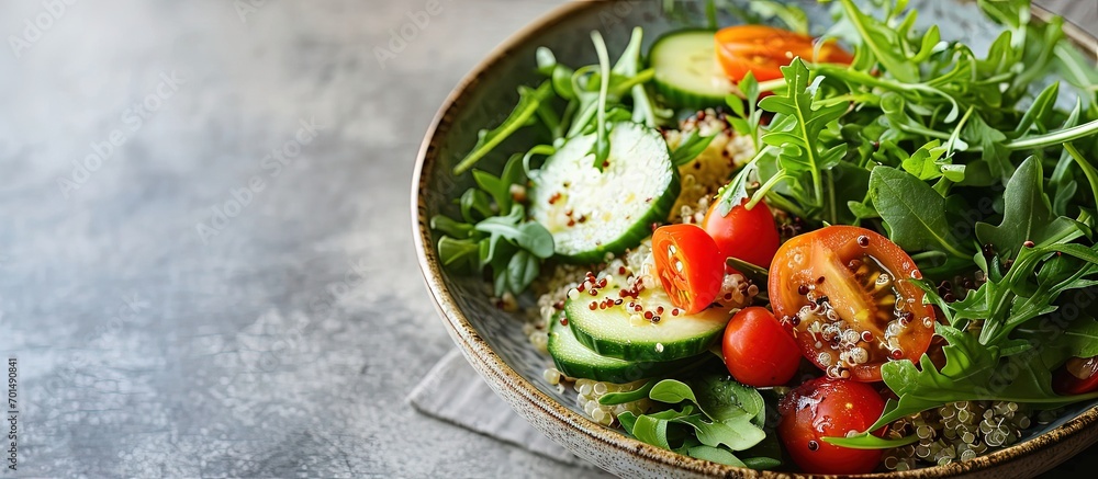 Poster quinoa salad with fresh tomatoes cucumbers and salad leaves. creative banner. copyspace image