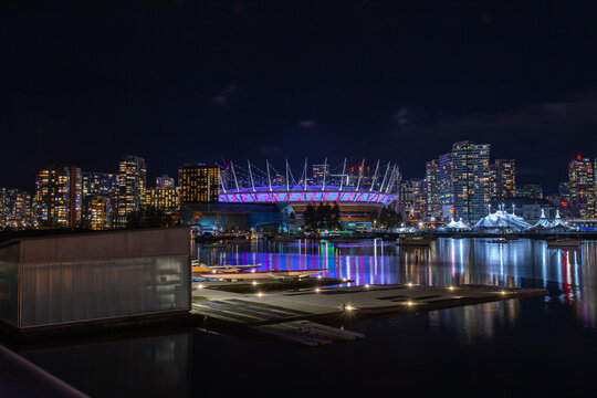 Vancouver, CANADA - Dec 31 2023 : Photo of BC Place Stadium and False Creek on New Year's Eve..Vibrant lights and lights celebrating the year 2024 and beautiful night view